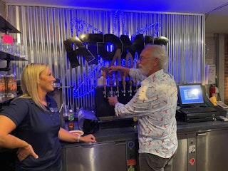 A man pours a pint from a draft beer tap at Atomic Ale Brewpub and Eatery in Richland.